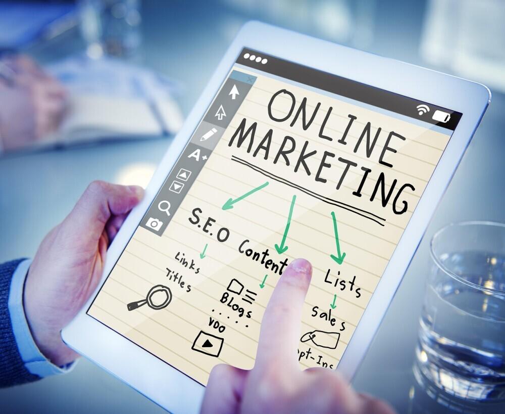 Man hands holding book on Online Marketing