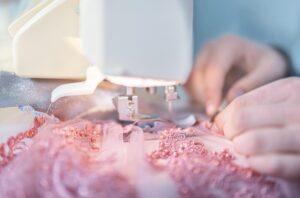 sewing machine with fabric and hands