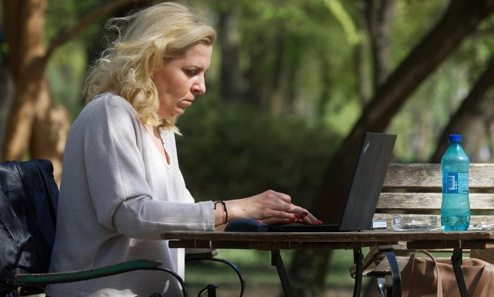 Women working on a laptop in the park